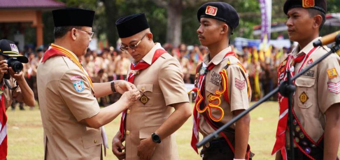 Gubernur Rohidin Mersyah saat Memasang Pin Pramuka Kepada Bupati Bengkulu selatan Gusnan Mulyadi